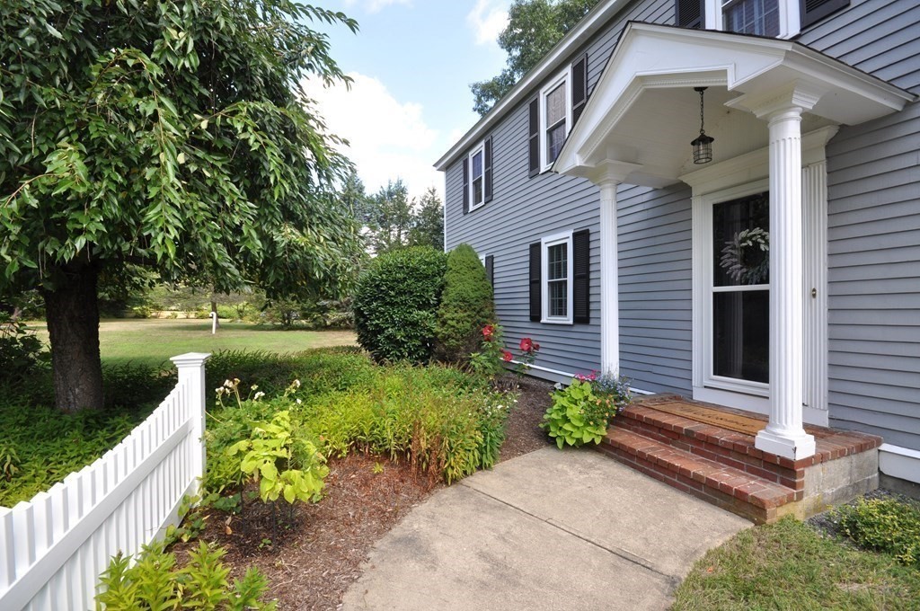 131 Sugar Road Bolton, MA 01740 - Photo 30 of 37 a front view of a house with garden