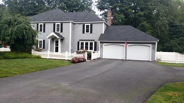 131 Sugar Road Bolton, MA 01740 - Photo 35 of 37 a front view of a house with a yard and garage