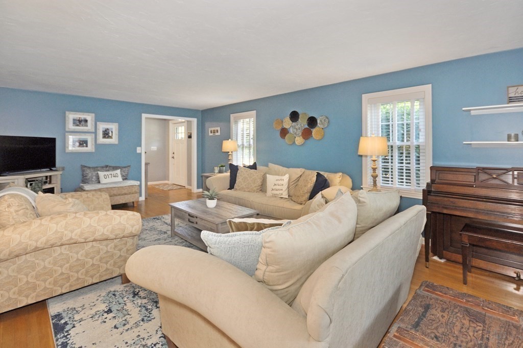 131 Sugar Road Bolton, MA 01740 - Photo 5 of 37 a living room with furniture and a flat screen tv