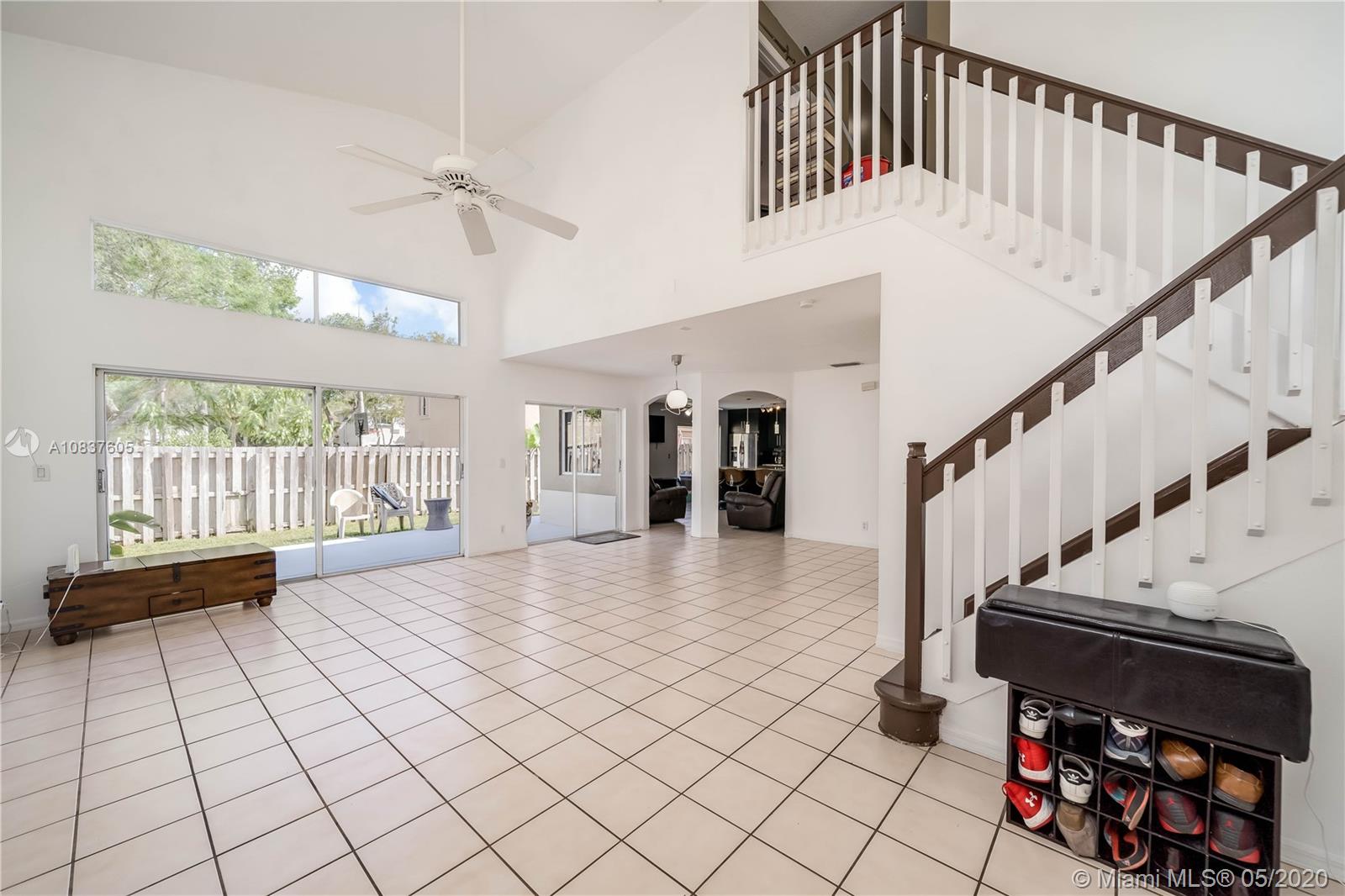 11325 Roundelay Road Cooper City, FL 33026 - Photo 4 of 46 Lots of light into formal LR/DR area with three sliders to backyard