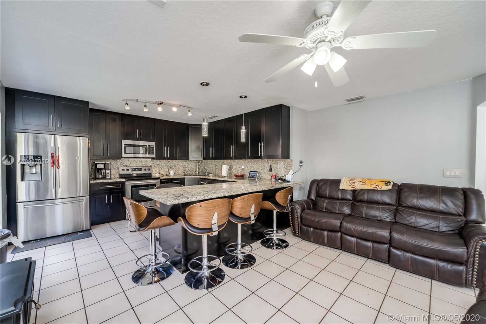 11325 Roundelay Road Cooper City, FL 33026 - Photo 9 of 46 Large Granite breakfast bar with matching backsplash
