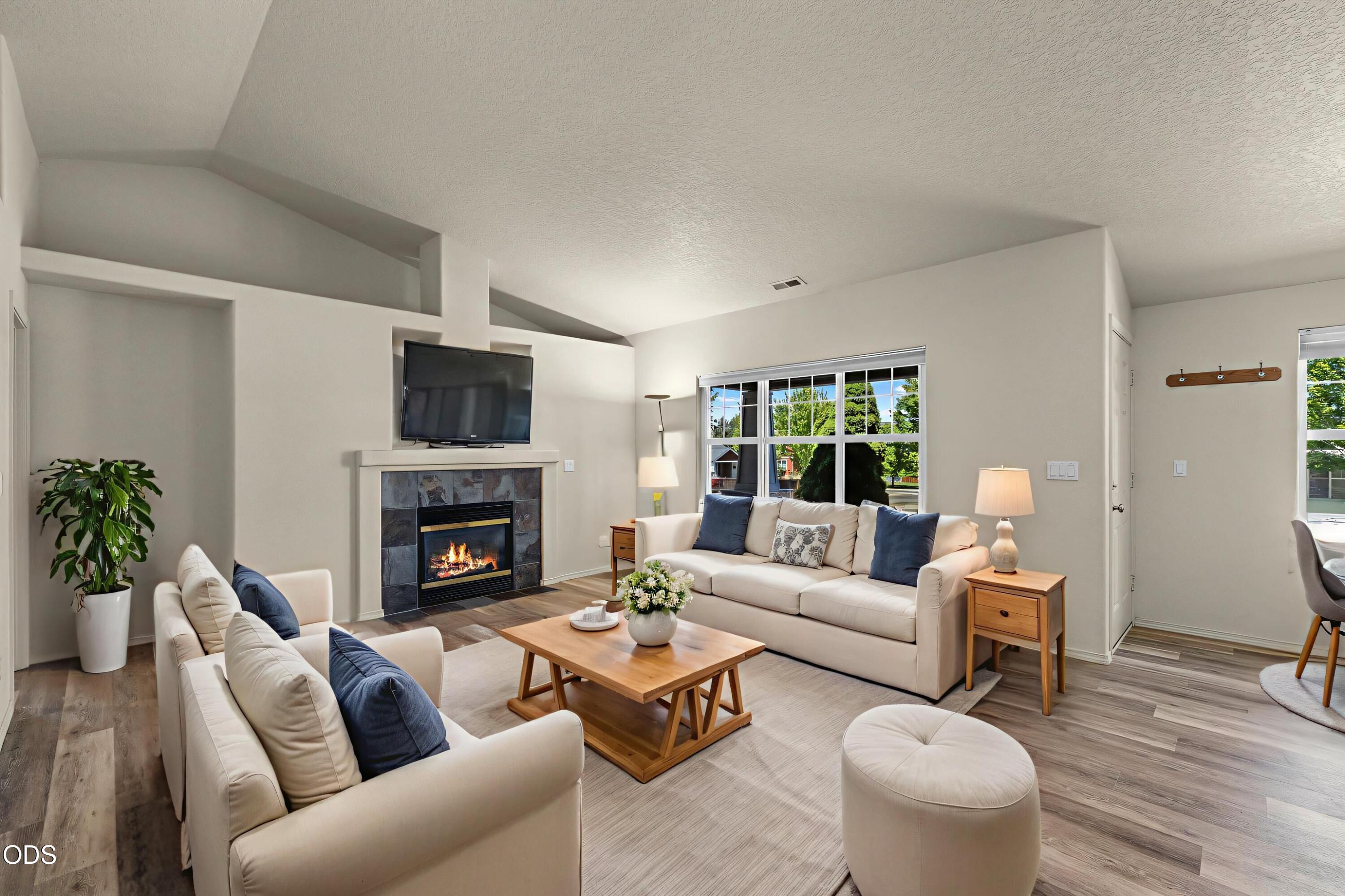 20535 Sunderland Way Bend, OR 97701 - Photo 14 of 41 a living room with furniture a fireplace and a large window