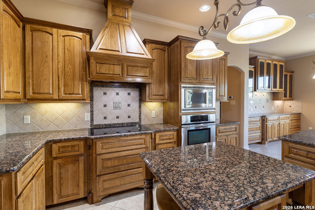 198 Echo Falls Road Comfort, TX 78013 - Photo 3 of 28 a kitchen with stainless steel appliances granite countertop a stove refrigerator and cabinets