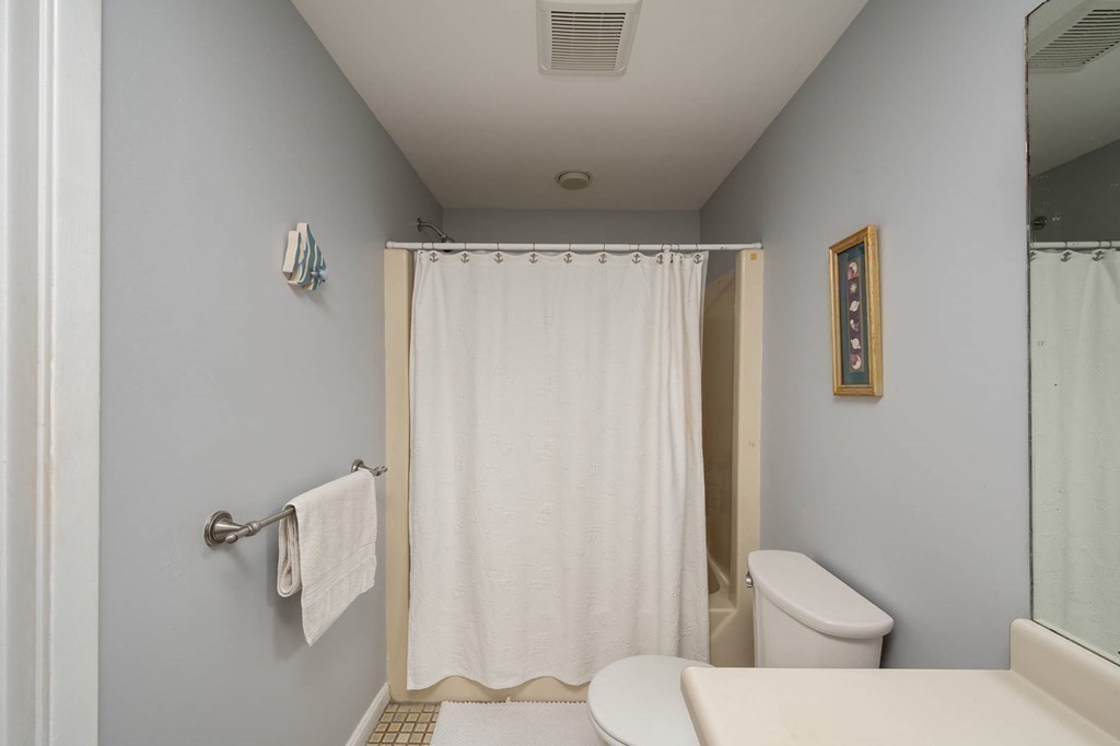 12 Spinnaker Hill Lane, Unit 12 Hull, MA 02045 - Photo 16 of 39 a white toilet sitting next to a bathroom sink