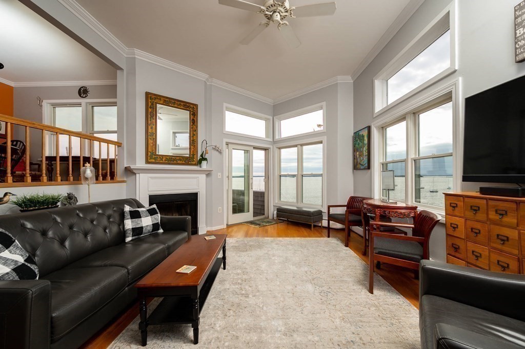 12 Spinnaker Hill Lane, Unit 12 Hull, MA 02045 - Photo 17 of 39 a living room with furniture a flat screen tv and a fireplace