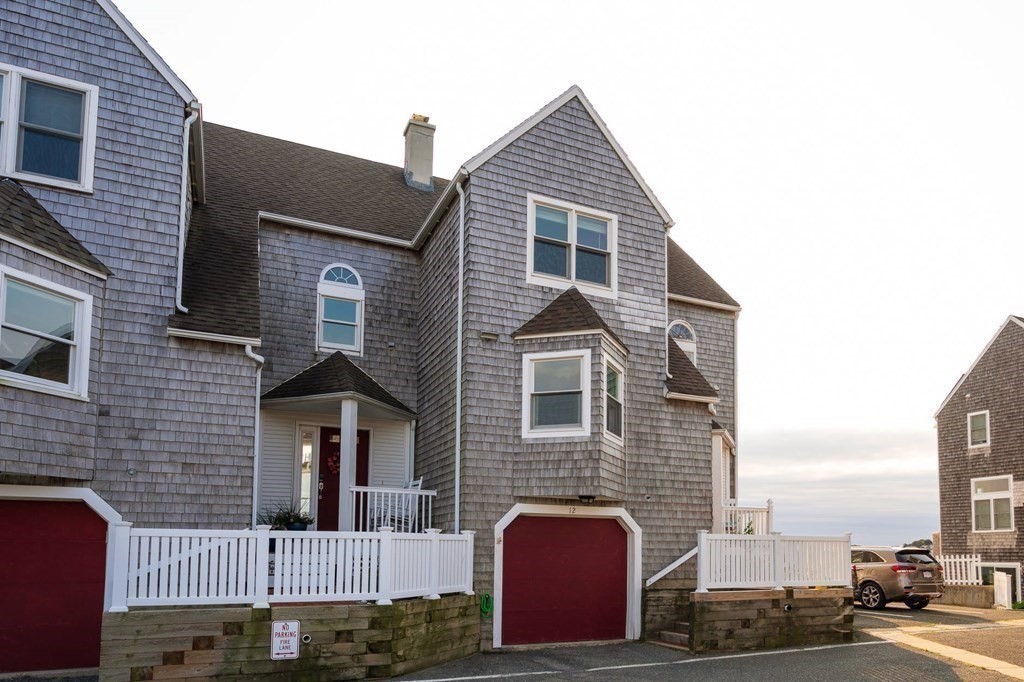 12 Spinnaker Hill Lane, Unit 12 Hull, MA 02045 - Photo 19 of 39 a front view of a house with a yard