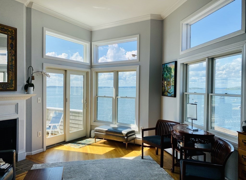 12 Spinnaker Hill Lane, Unit 12 Hull, MA 02045 - Photo 2 of 39 a living room with fireplace furniture and a large window