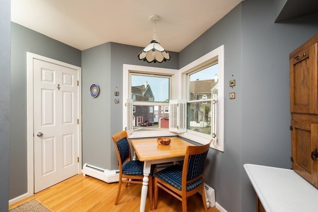 12 Spinnaker Hill Lane, Unit 12 Hull, MA 02045 - Photo 24 of 39 a view of a dining room with furniture window and wooden floor