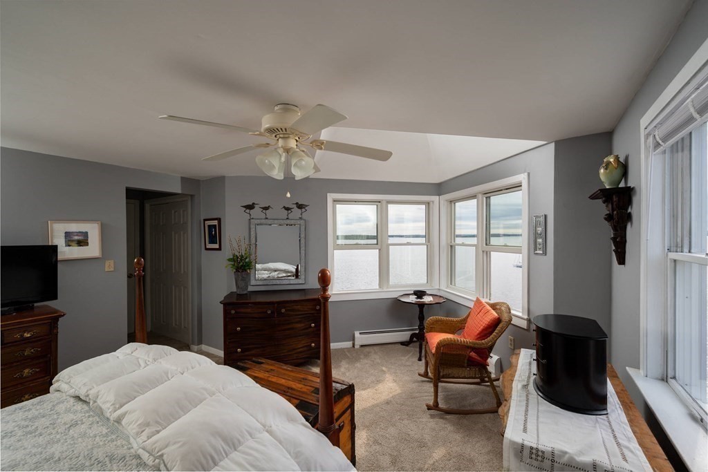 12 Spinnaker Hill Lane, Unit 12 Hull, MA 02045 - Photo 25 of 39 a bedroom with furniture and a window