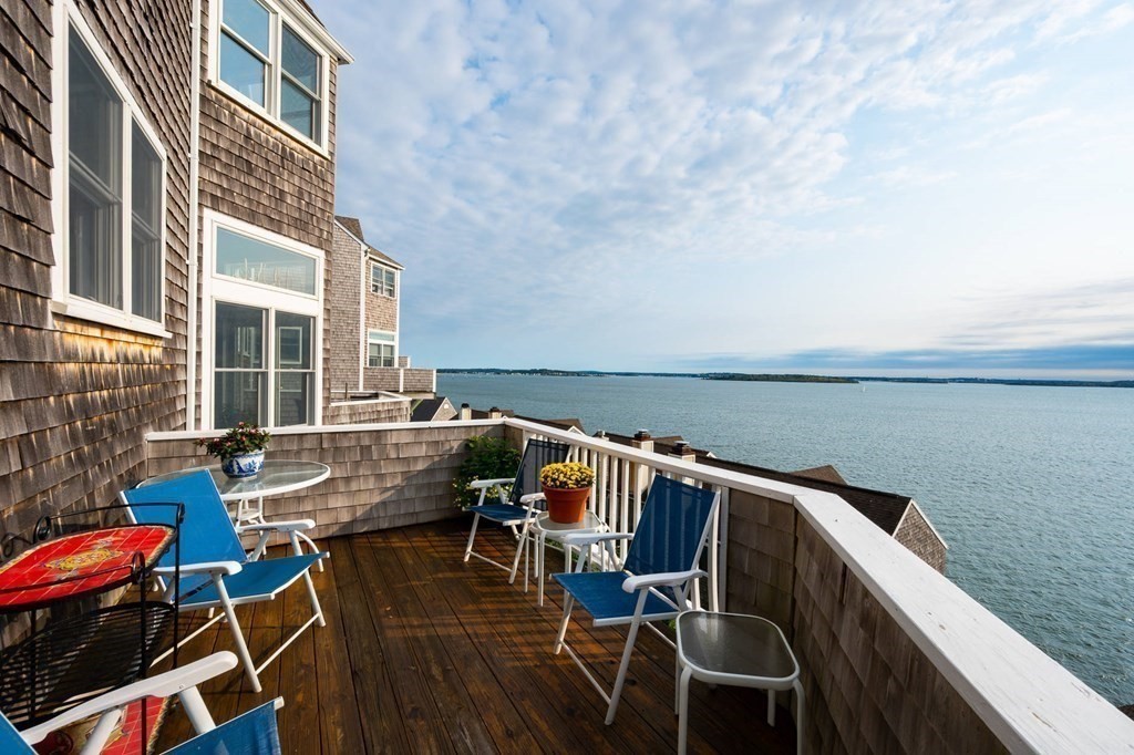 12 Spinnaker Hill Lane, Unit 12 Hull, MA 02045 - Photo 8 of 39 a terrace with outdoor seating and wooden floor