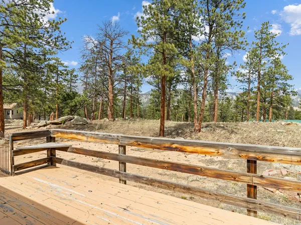 a dining room with furniture a fireplace and wooden floor