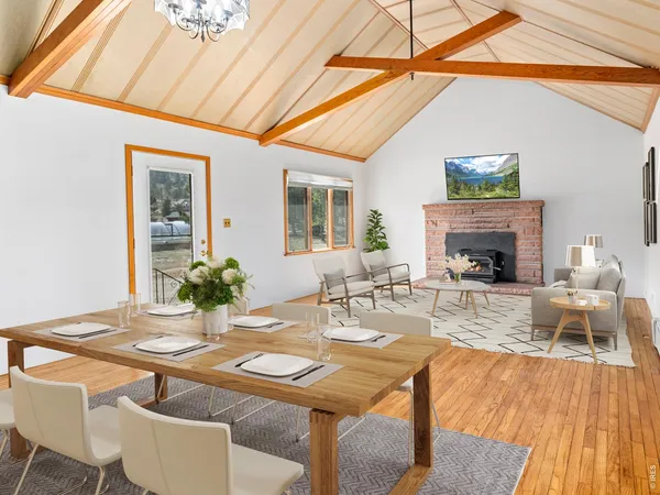 a view of an empty room with a fireplace and a window