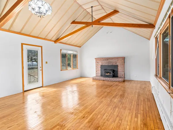 a view of an empty room with a fireplace