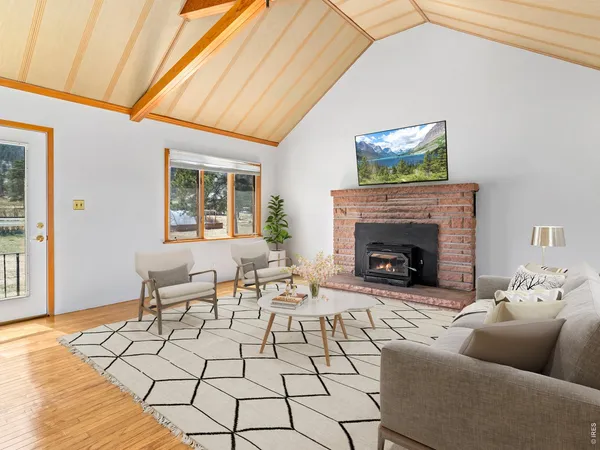 a view of empty room with wooden floor and fireplace