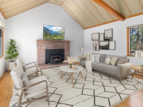 a view of empty room with wooden floor and fireplace