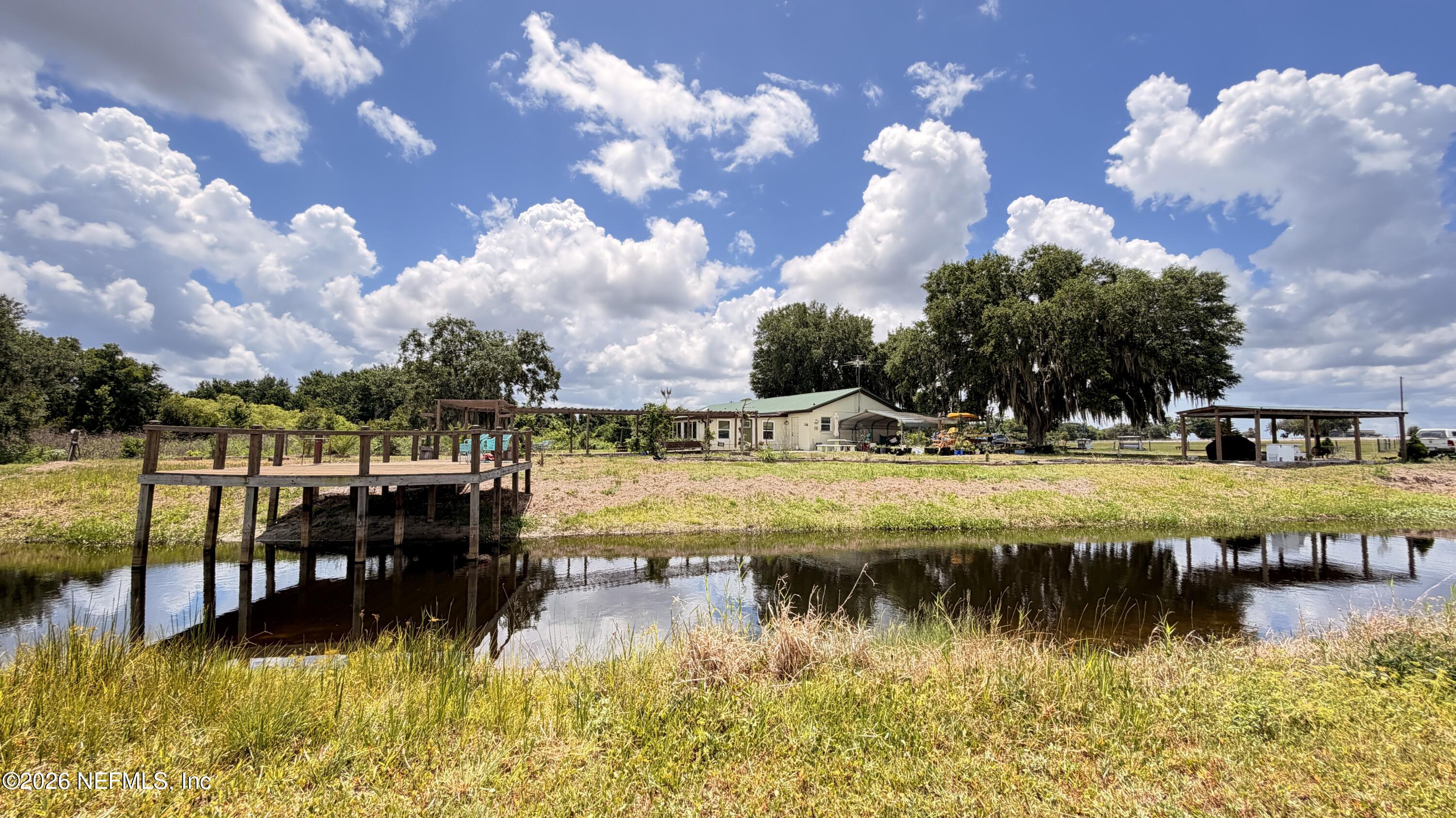 1302 Fort Meade Road Frostproof, FL 33843 - Photo 12 of 39 a view of a lake with houses in the back
