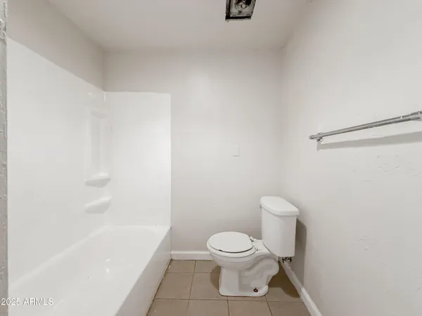a bathroom with a toilet and a bathtub