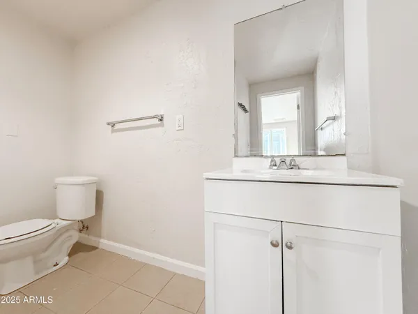 a bathroom with a toilet a sink and mirror