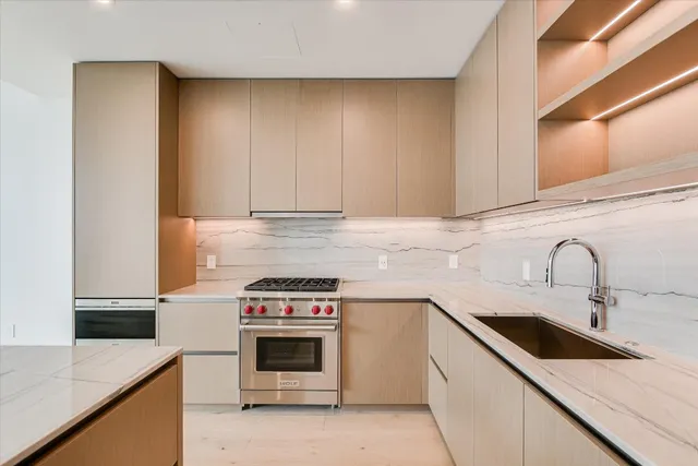 a kitchen with a sink and a stove top oven