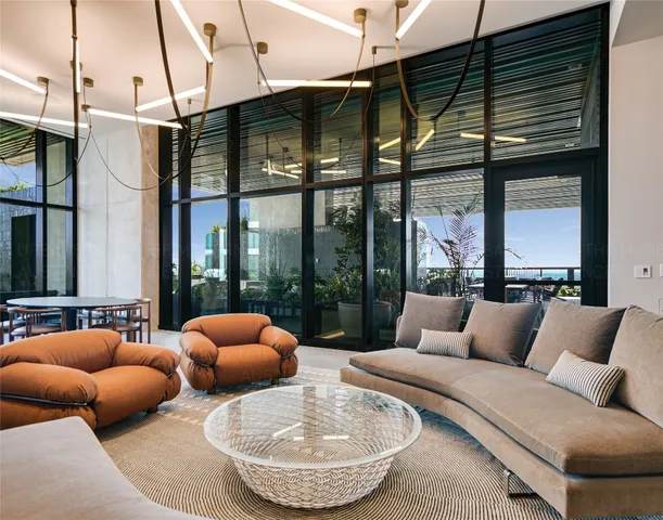 a outdoor living room with furniture and a large window