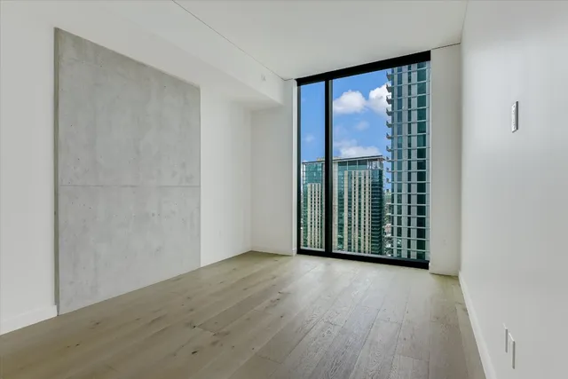 a view of a room with wooden floor and a window