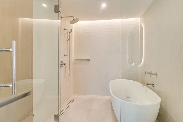a bathroom with a bathtub and shower