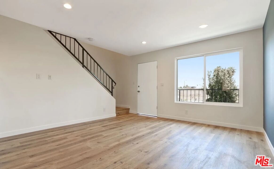 110 South Eucalyptus Avenue, Unit 5 Inglewood, CA 90301 - Photo 2 of 12 a view of an empty room with wooden floor and a window