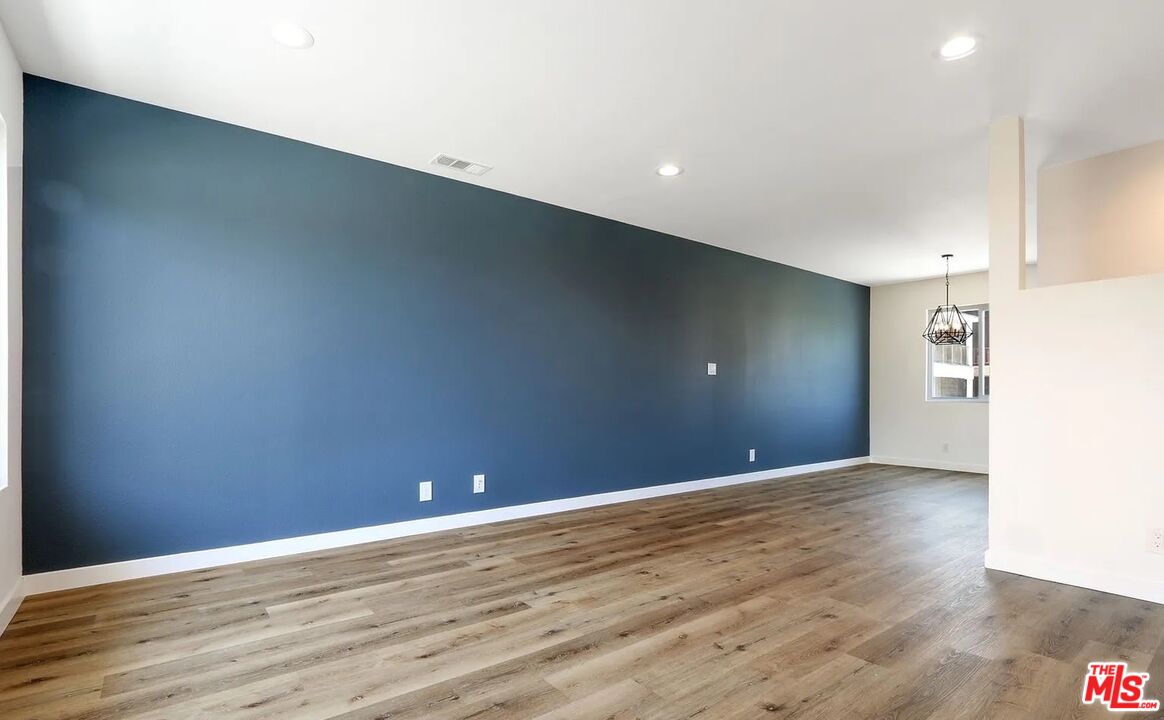 110 South Eucalyptus Avenue, Unit 5 Inglewood, CA 90301 - Photo 4 of 12 a view of an empty room with wooden floor