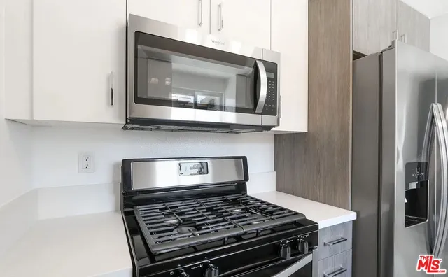 a kitchen with a stove and a microwave