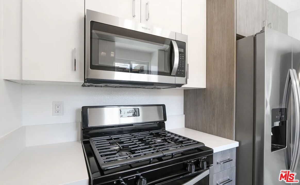 110 South Eucalyptus Avenue, Unit 5 Inglewood, CA 90301 - Photo 6 of 12 a kitchen with a stove and a microwave