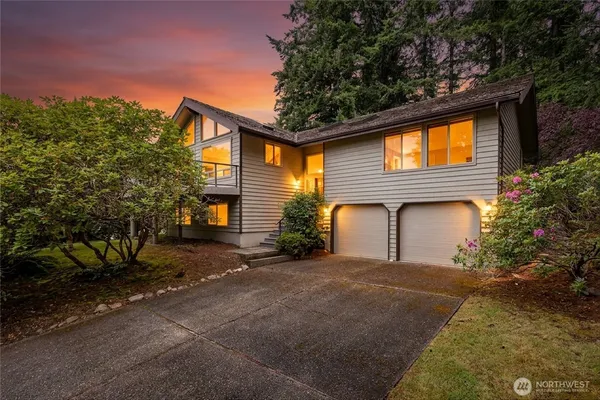 a front view of a house with a yard and garage