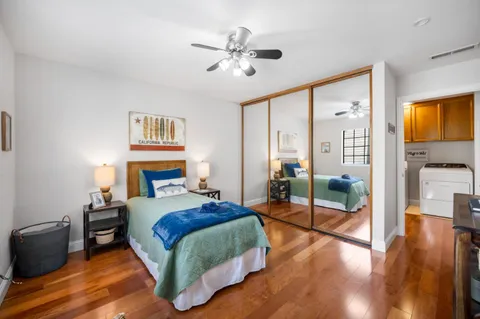 a bedroom with a bed and wooden floor