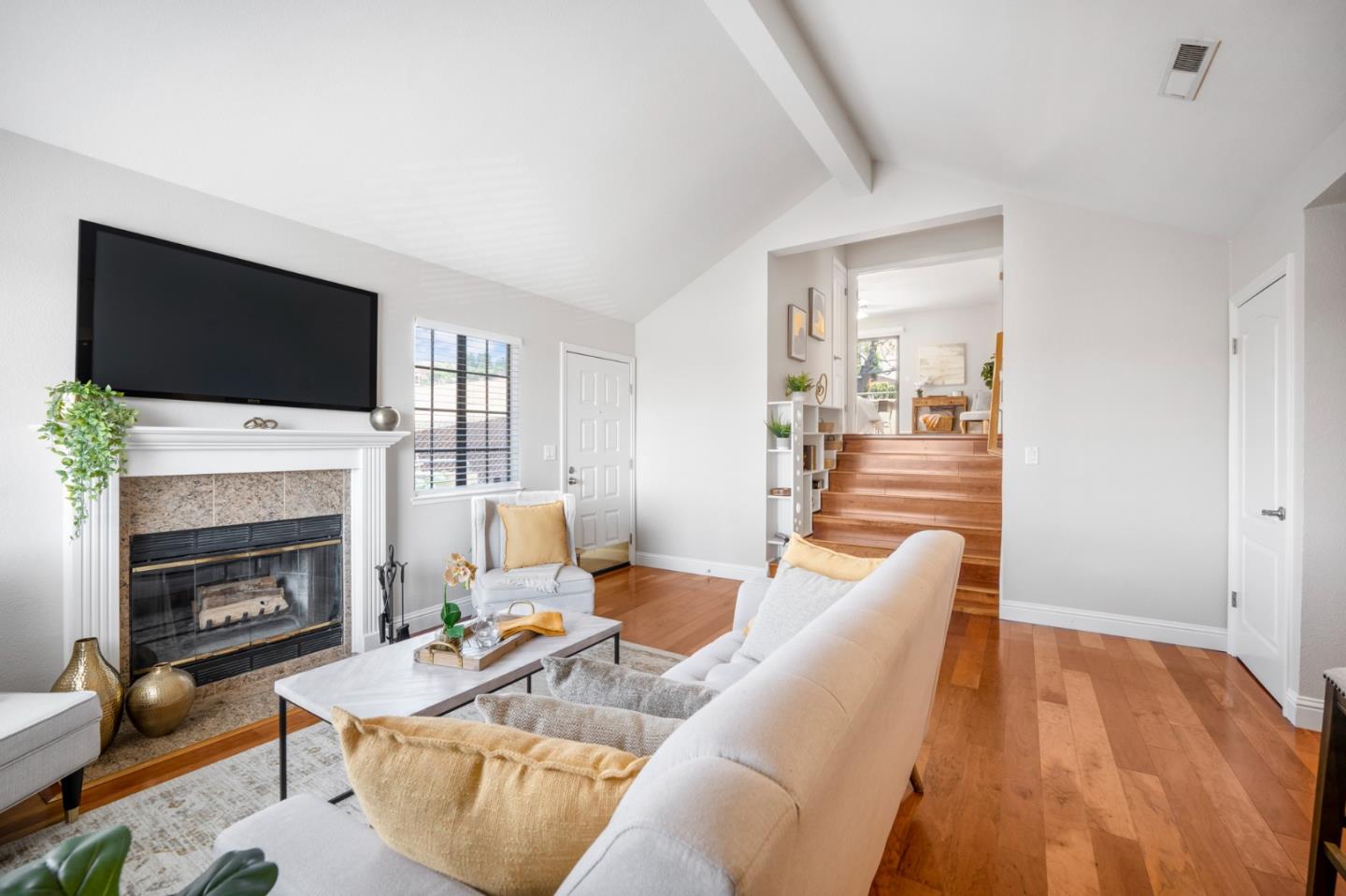 3053 Elk Ridge Court San Jose, CA 95136 - Photo 4 of 21 a living room with furniture a fireplace and a flat screen tv