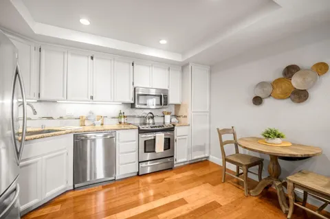 a kitchen with a sink cabinets and stove top oven