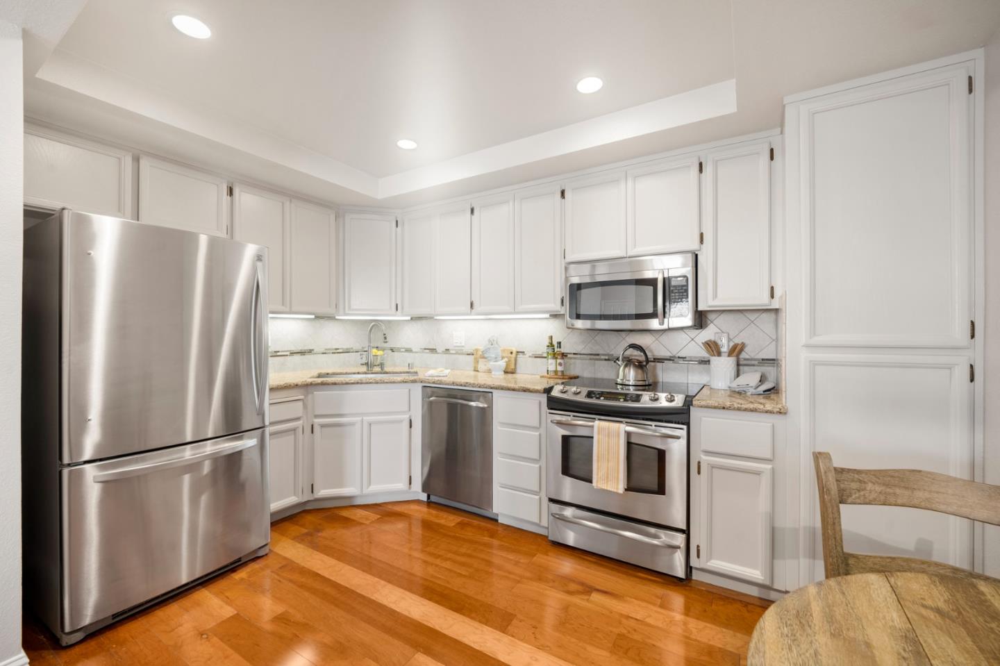 3053 Elk Ridge Court San Jose, CA 95136 - Photo 6 of 21 a kitchen with stainless steel appliances granite countertop a refrigerator stove and microwave