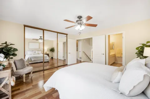 a spacious bedroom with a bed and a chandelier
