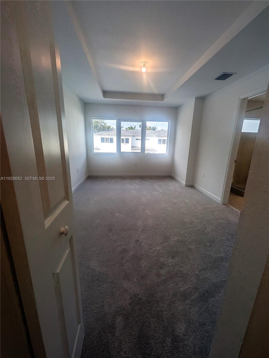 5180 Southwest 37th Street, Unit 5180 Hollywood, FL 33023 - Photo 15 of 25 a view of an empty room with wooden floor and a window