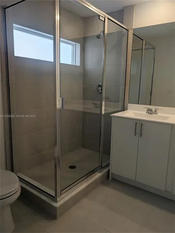 a bathroom with a shower a toilet and sink