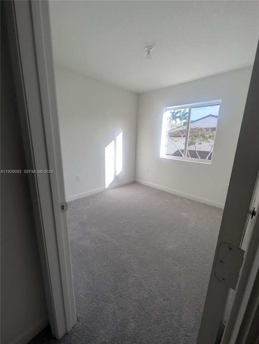 5180 Southwest 37th Street, Unit 5180 Hollywood, FL 33023 - Photo 21 of 25 a view of empty room with windows