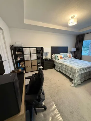 a bedroom with a bed window and chair