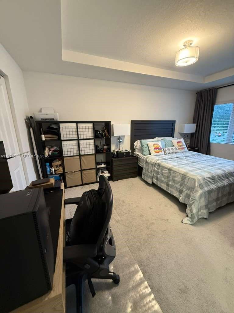 5180 Southwest 37th Street, Unit 5180 Hollywood, FL 33023 - Photo 22 of 25 a bedroom with a bed window and chair