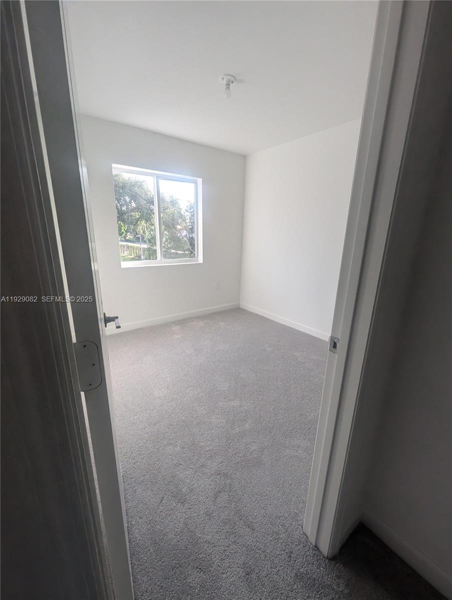 5180 Southwest 37th Street, Unit 5180 Hollywood, FL 33023 - Photo 23 of 25 an empty room with windows