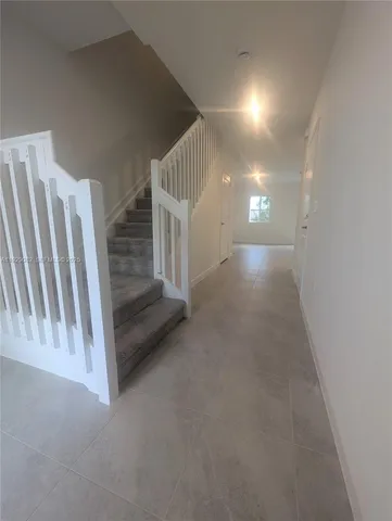 a view of a livingroom with stairs and white walls