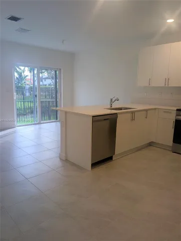 a view of an empty room with glass door