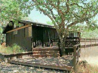 a view of a wooden deck with a yard