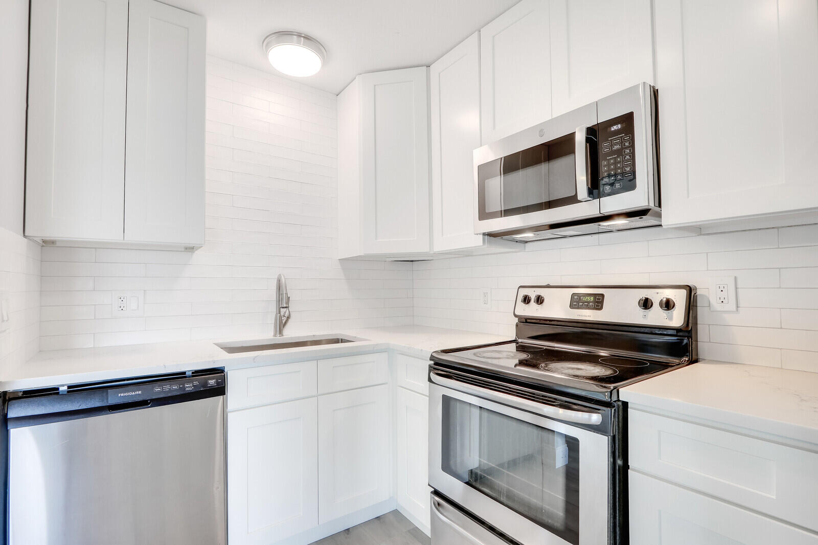 3852 Gull Road Palm Beach Gardens, FL 33410 - Photo 12 of 30 a kitchen with cabinets stainless steel appliances and a sink