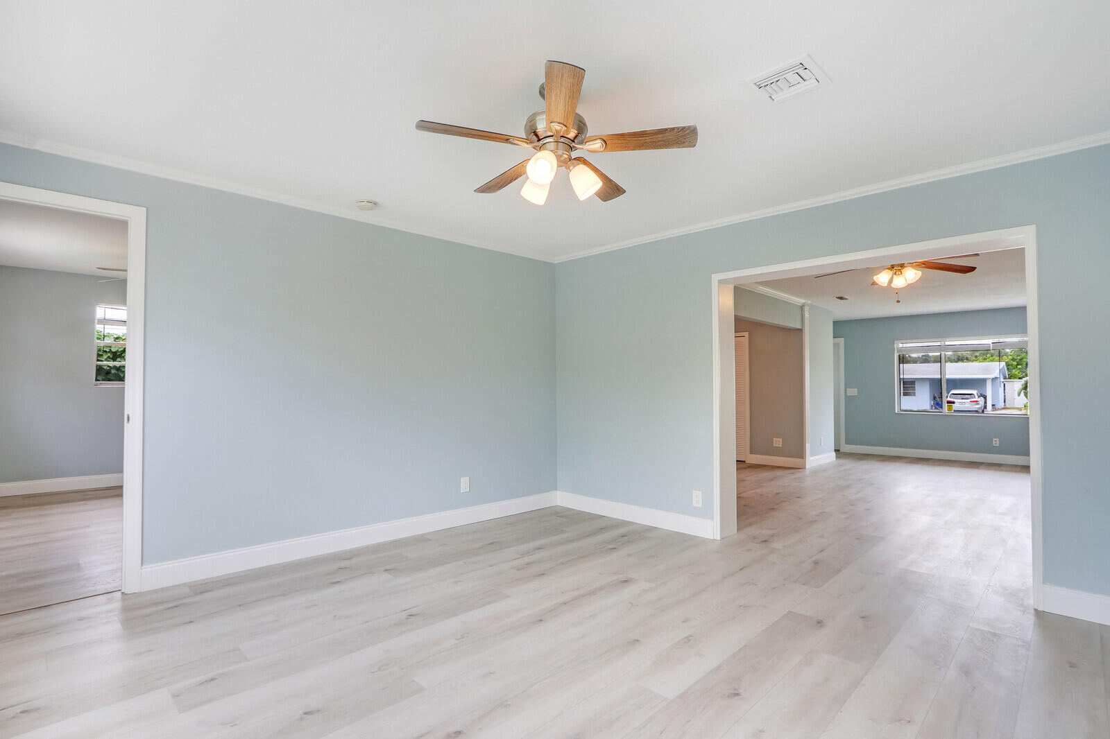 3852 Gull Road Palm Beach Gardens, FL 33410 - Photo 13 of 30 wooden floor in an empty room with a window