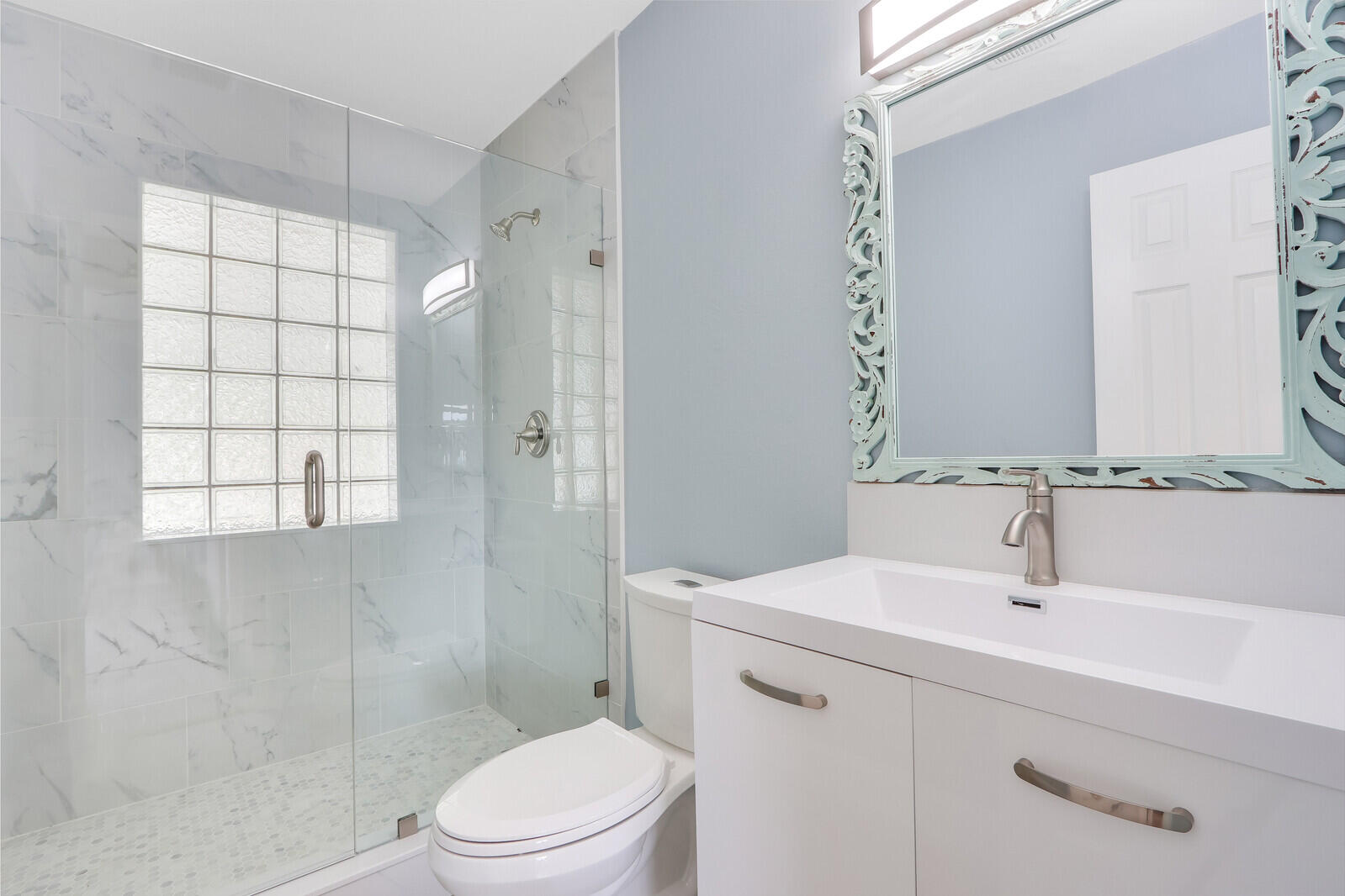 3852 Gull Road Palm Beach Gardens, FL 33410 - Photo 19 of 30 a bathroom with a sink toilet and shower