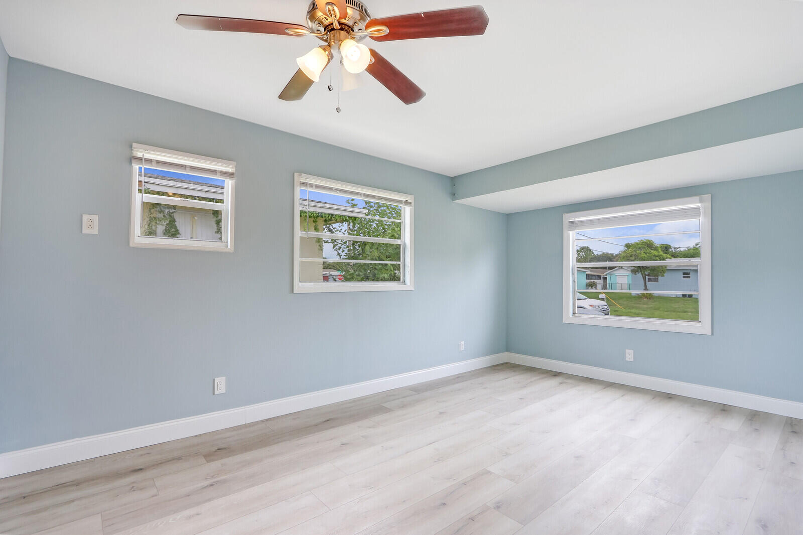 3852 Gull Road Palm Beach Gardens, FL 33410 - Photo 20 of 30 a view of an empty room with a window and a ceiling fan