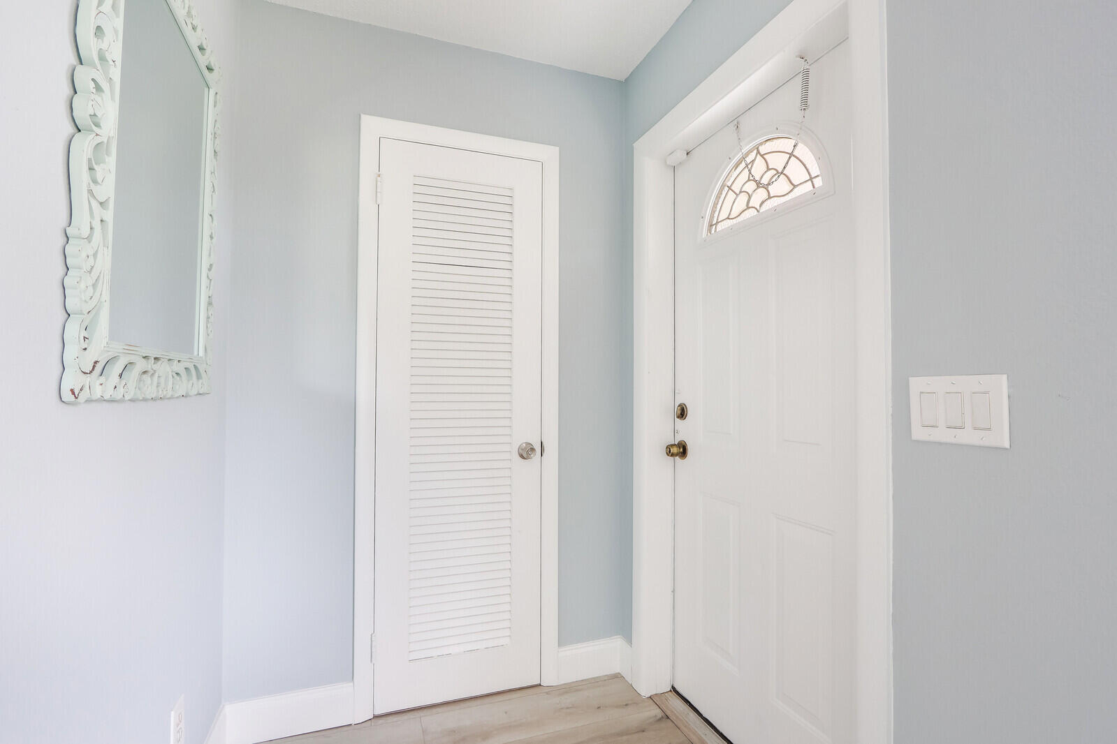 3852 Gull Road Palm Beach Gardens, FL 33410 - Photo 2 of 30 a view of a hallway with wooden floor
